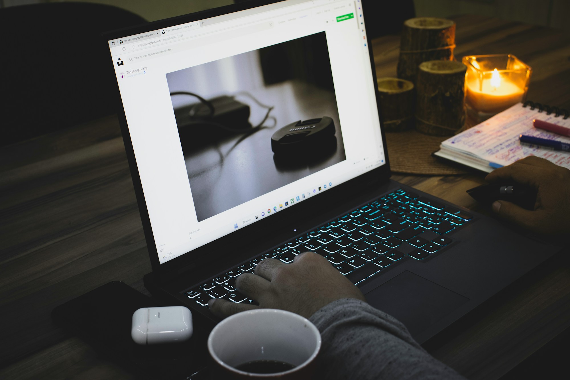 Hands working with AI on a laptop